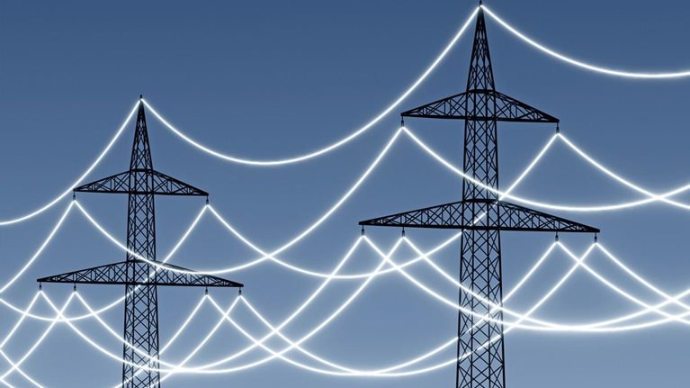 Electricity pylons with glowing power lines to emphasize technology