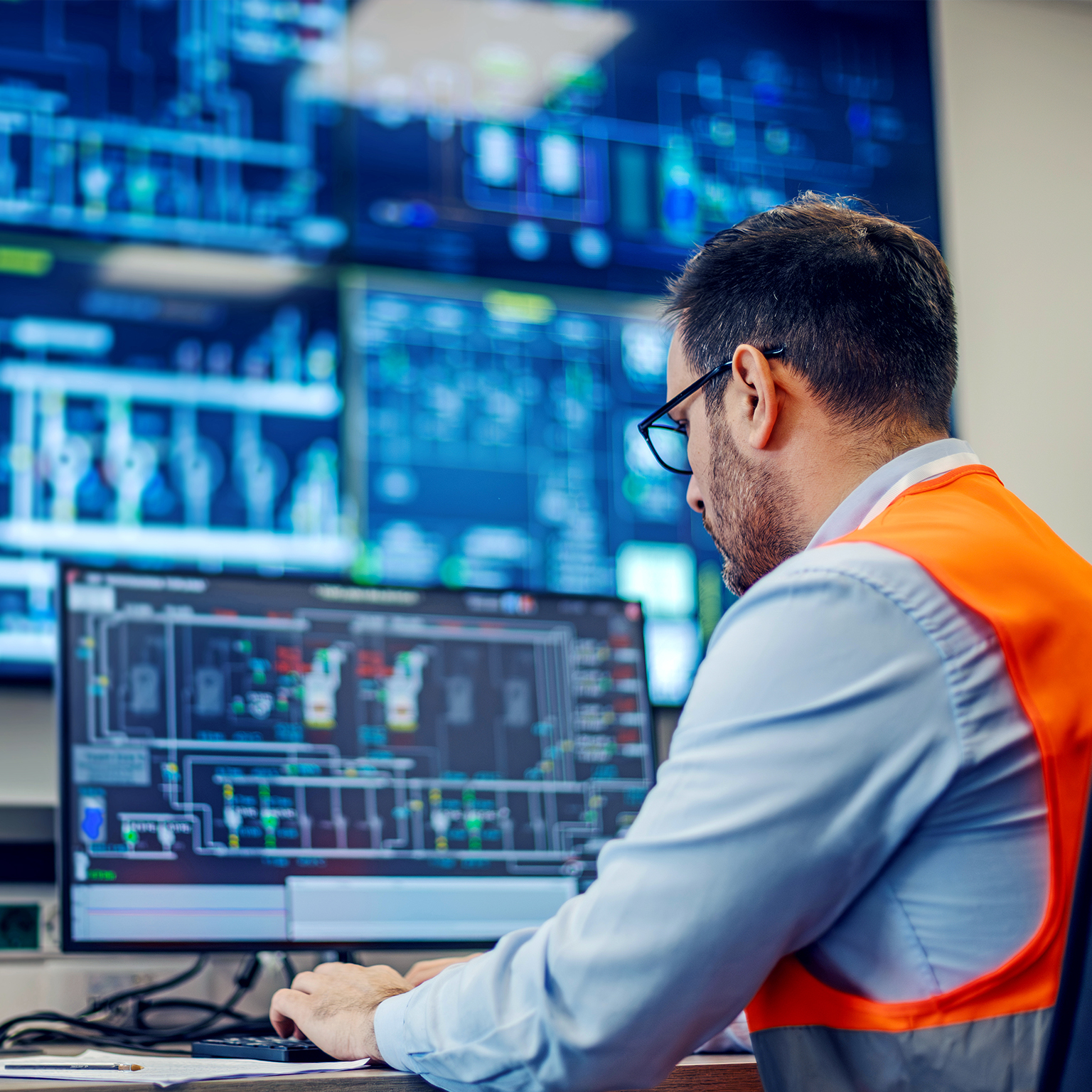 Engineer monitoring industrial process control system