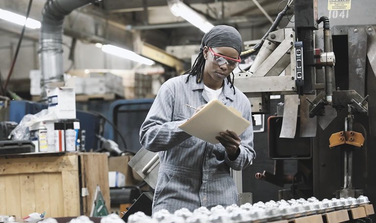 Factory employee taking notes