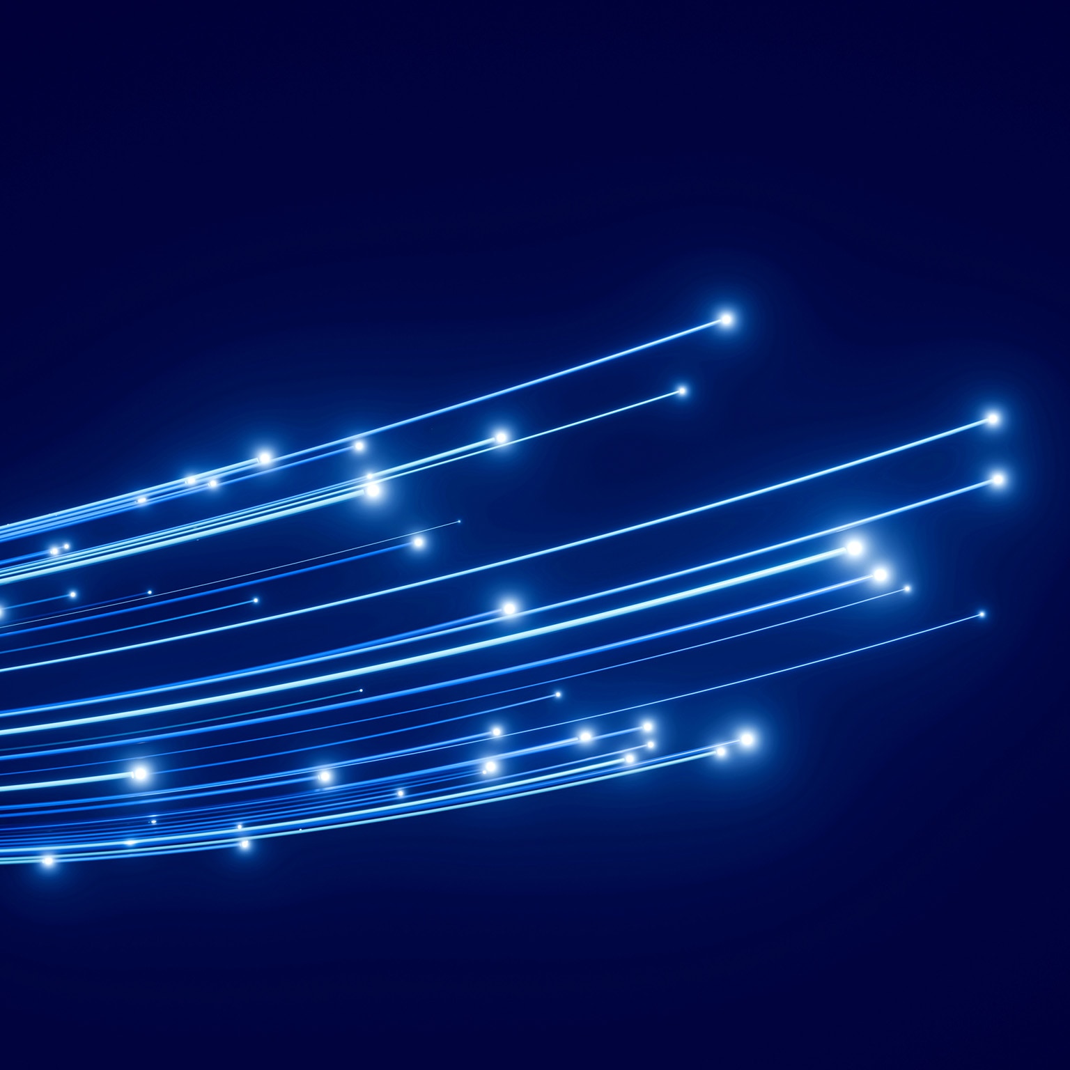 Abstract image of curved blue light trails with glowing points on a dark blue background.