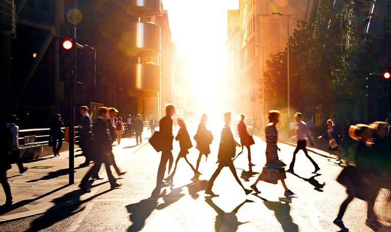 Business people walking through at city at dawn