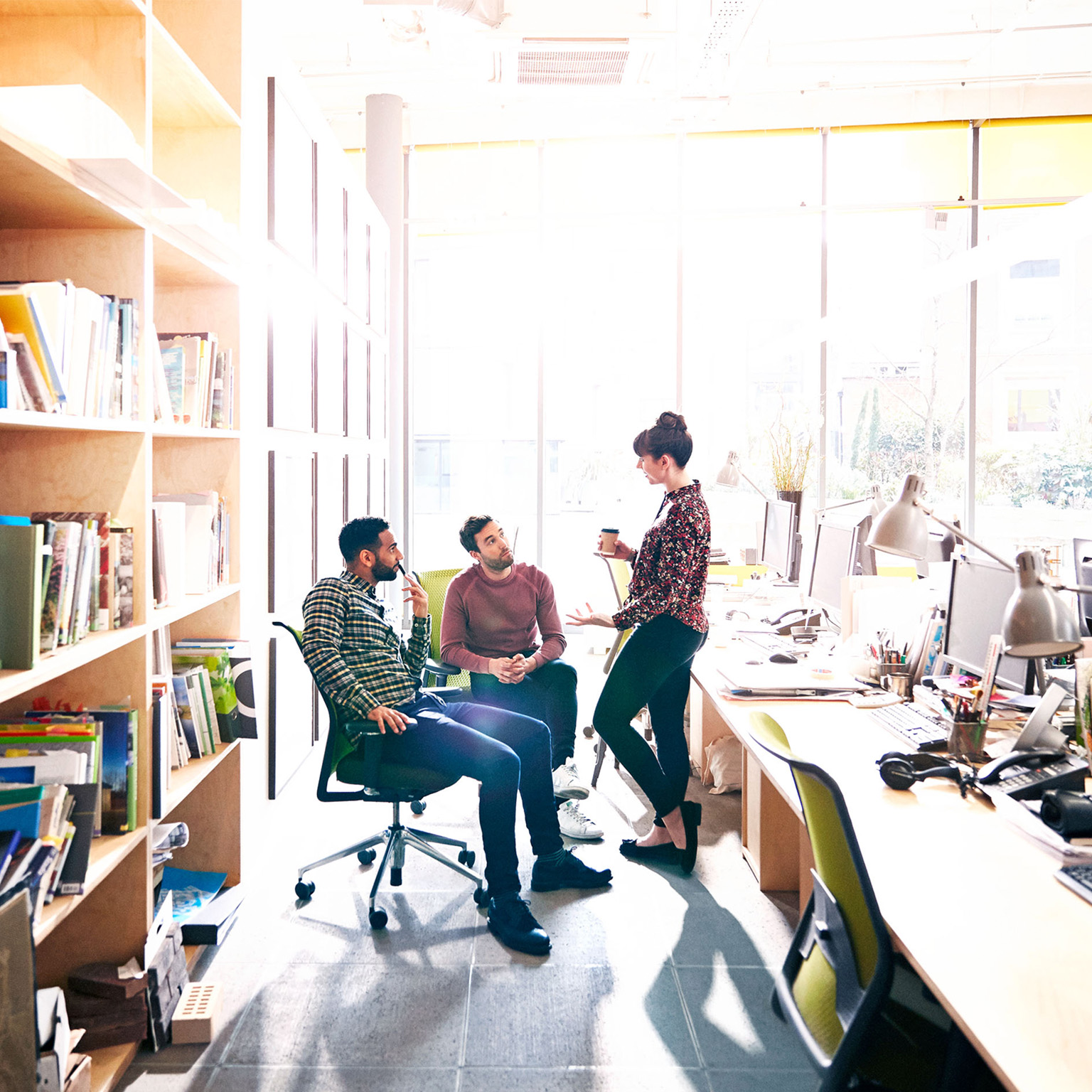 Creative coworkers chatting over ideas in office