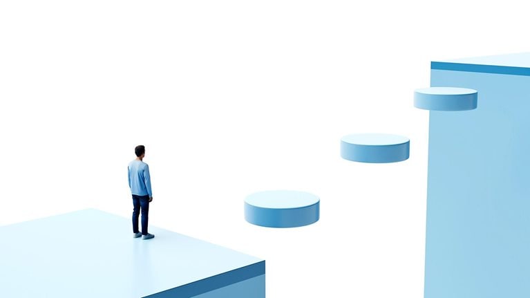 Conceptual image of a person in a blocky 3D environment, standing at the edge of a chasm with floating disks forming a walkway across.