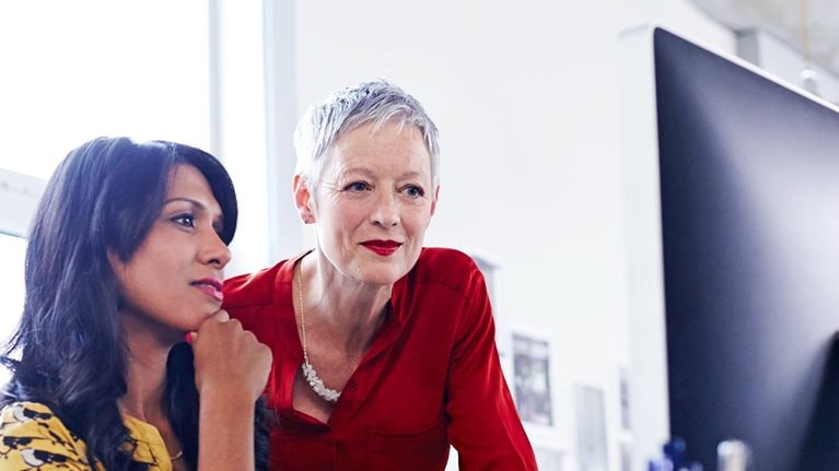 Two women before a screen