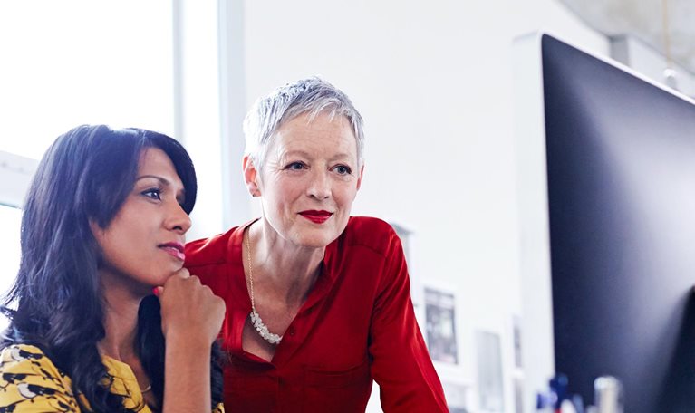 Two women before a screen