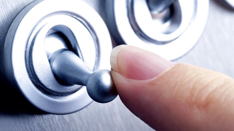 Close-up image of a person flicking a switch.