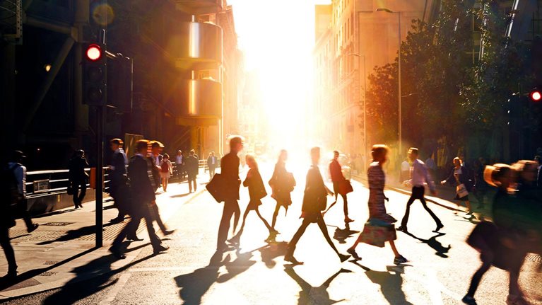 Business people walking through at city at dawn