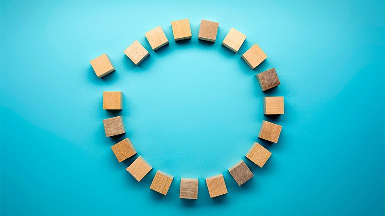 Wooden blocks in a circle on a blue background