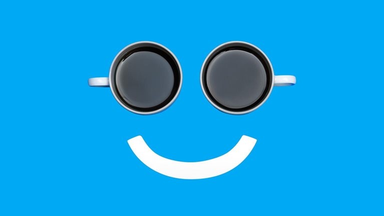 A smiley face with two coffee cups for the eyes and a white line for the mouth.