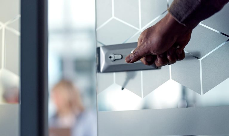 Close up of unrecognizable businessman opening an office door while entering