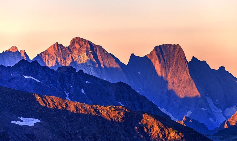 An image of a majestic mountain ridge-line at first light.