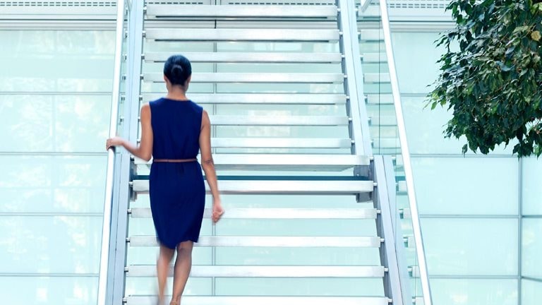 A woman walking up a staircase.