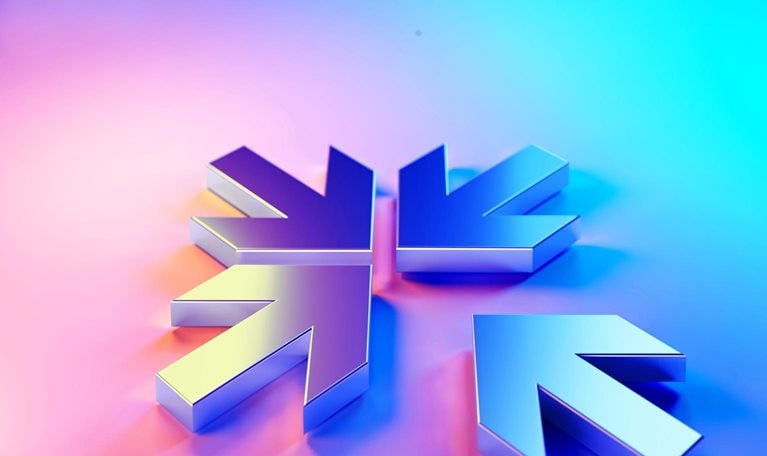 Four metallic arrows, pointing inward, creating a snowflake like shape. The arrows are rendered in a gradient of purple and blue, giving a modern, almost holographic effect.