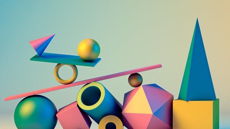 Sphere, square, pentagon, and other three-dimensional shapes in bright colors balancing on a see-saw