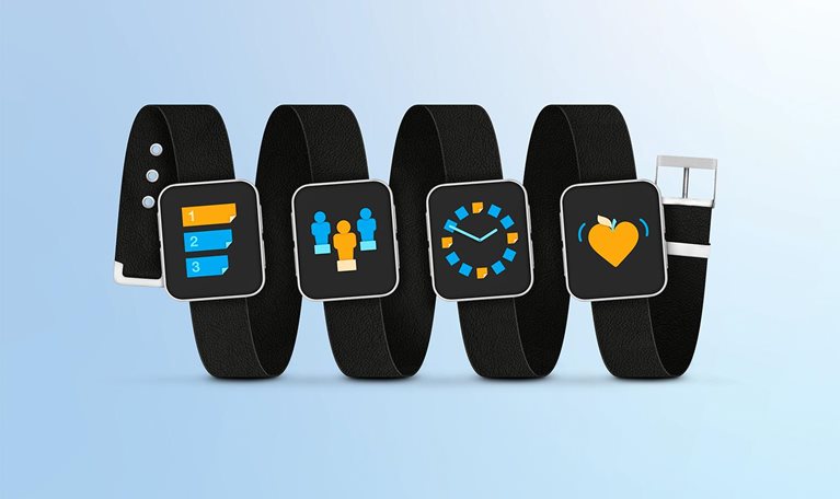 Four smartwatch dials are mounted on a single leather wristband. Dial one features an icon representing Priorities, dial two an icon for Roles, dial three an icon for Time Management, and dial four an icon symbolizing Energy and Wellbeing.