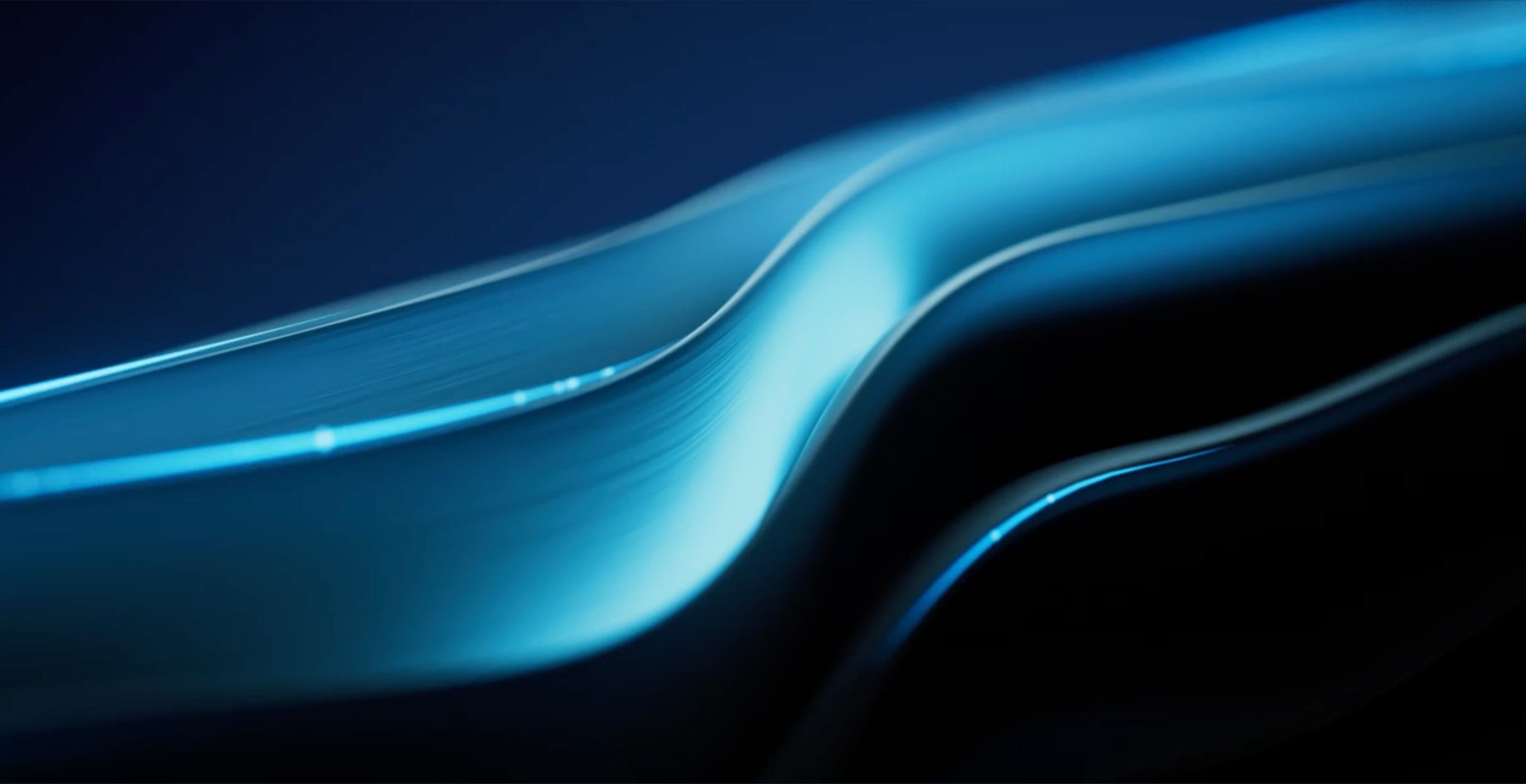 Smooth, flowing blue curves with light reflections against a dark background, creating a serene and futuristic abstract visual.