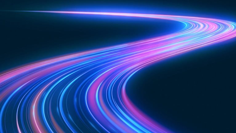 Glowing blue, purple, and pink light trails curve through a dark blue space, forming a sweeping path that winds toward the horizon, suggesting acceleration, technological progress, or the evolving direction of AI.
