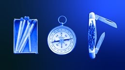 Matchsticks, compass and knife on wooden board