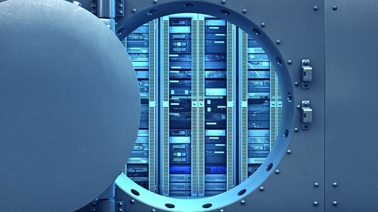 Image of an open vault door revealing computer servers within.