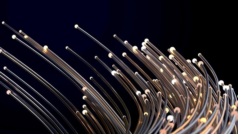 Thin metallic wires of different lengths with small lights at their ends bending together against a dark background for added drama.