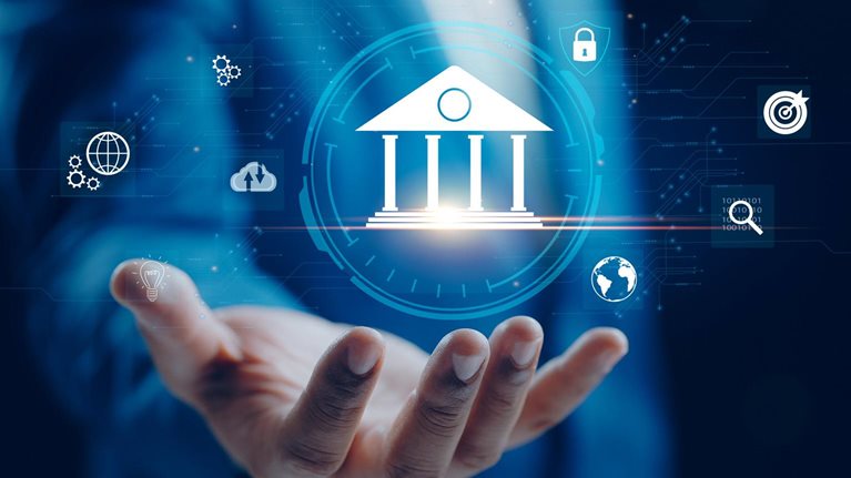 A businessperson holds out a hand beneath a digital bank icon surrounded by symbols for data, security, analytics, and connectivity, representing the interconnected digital systems used to create digital twins in banking.
