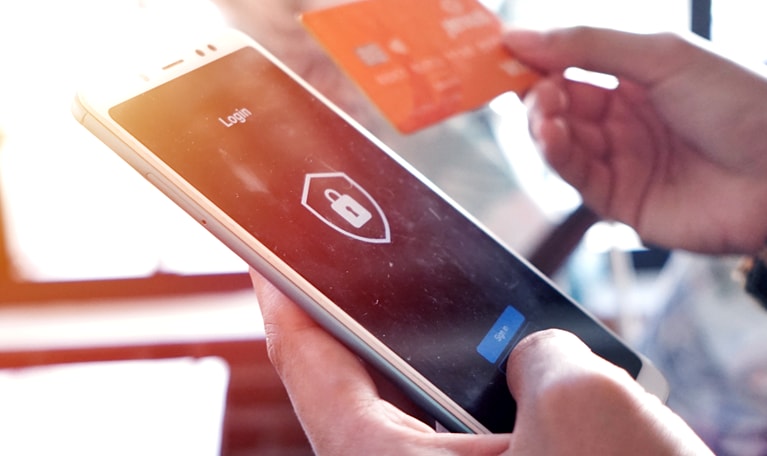 Logging into a mobile payment app with an online security system on a smartphone.