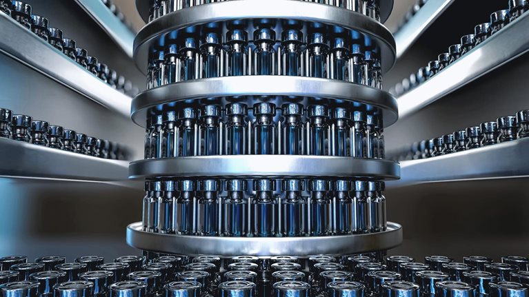 Photo of vaccine vials on an assembly line in preparation for rollout