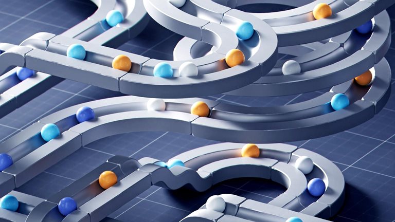 A complex network of smooth, interconnected tracks resembling a futuristic marble run, set against a dark blue grid background. Small spheres in blue, white, and orange are distributed along the winding paths, creating a sense of motion and intricate system design.