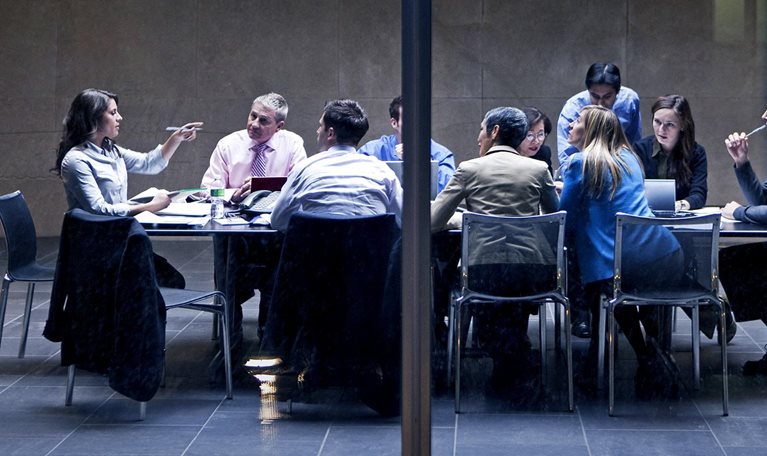 Image of a group of business professionals having a meeting in a modern office space.