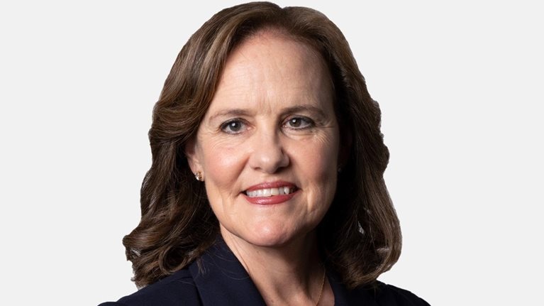 Michèle Flournoy with a light smile and a navy blazer.