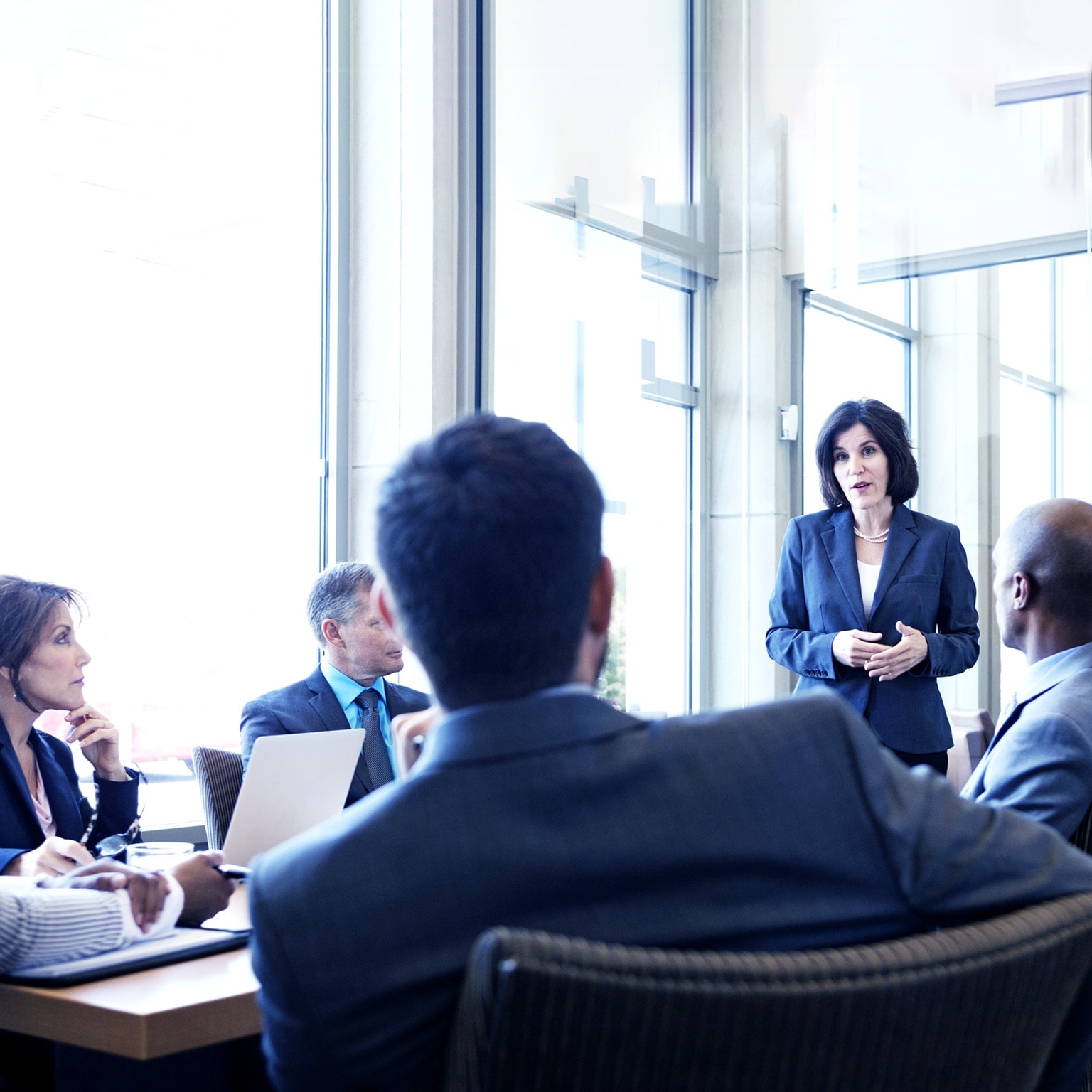 Businesswoman talking with colleagues during meeting in office