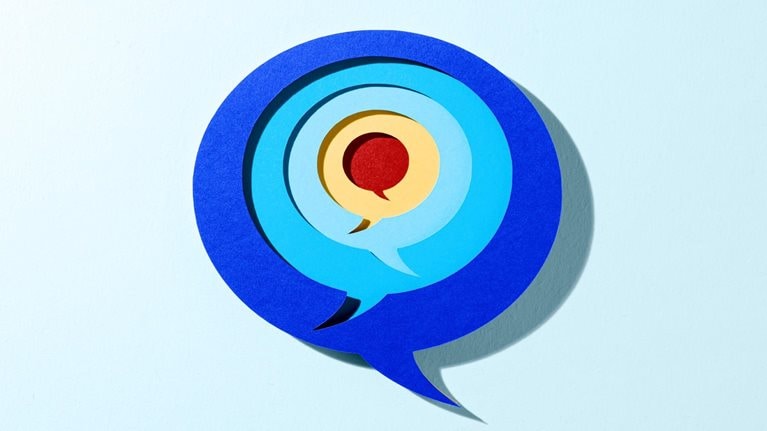A layered, paper-cut style illustration of overlapping speech bubbles arranged concentrically, with shades of deep blue on the outside and lighter blues toward the center. A yellow and red speech bubble sits at the core, and the entire design casts a soft shadow against a light blue background, creating a subtle three-dimensional effect.