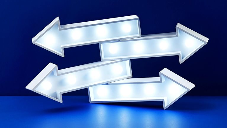 Image of four stacked lit up arrows pointing in different directions.