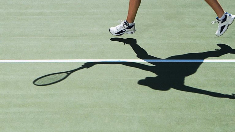 Tennis player at the baseline