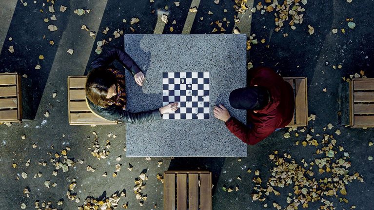 Aerial view of two people playing chess outside