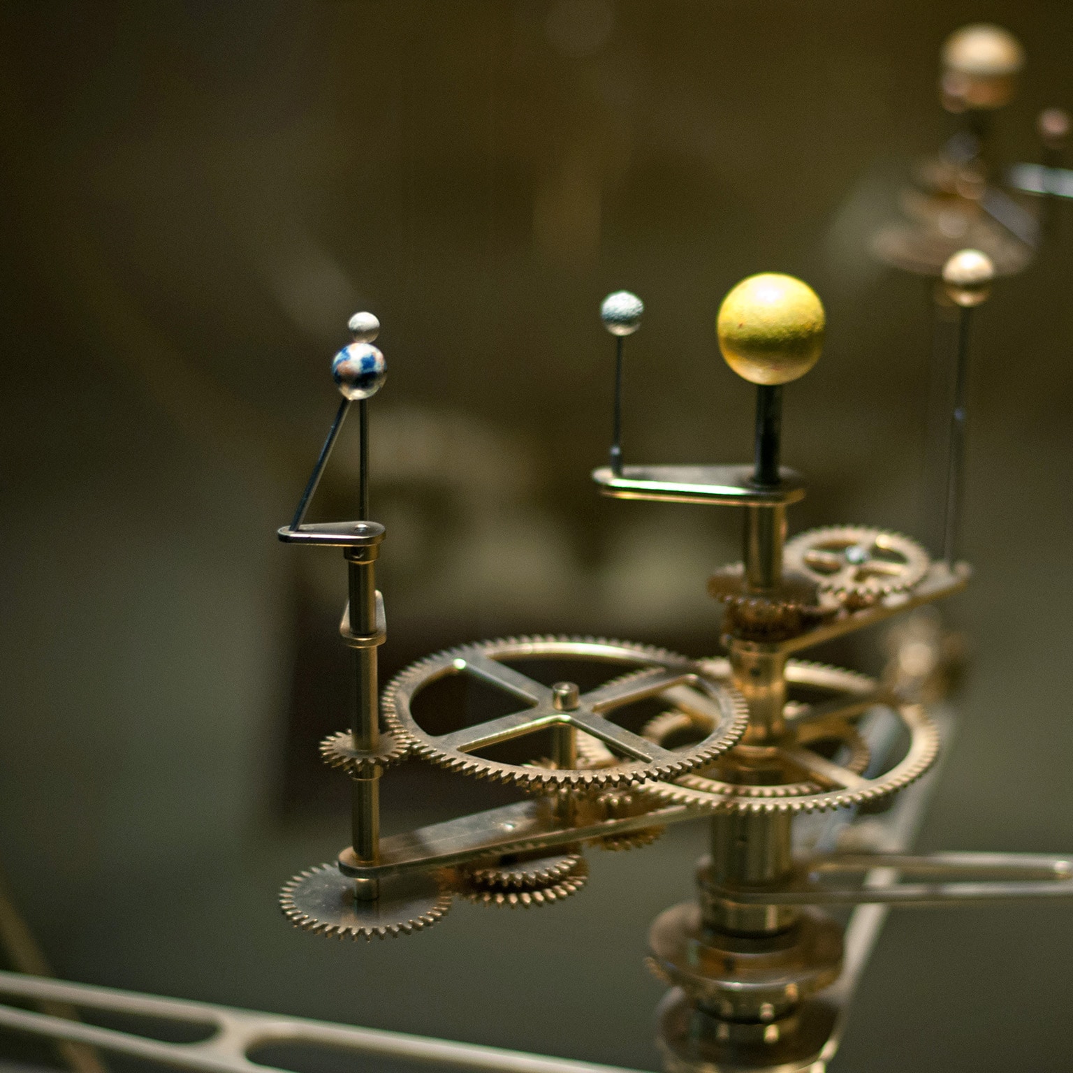 A mechanical device illustrating how the solar system revolves.