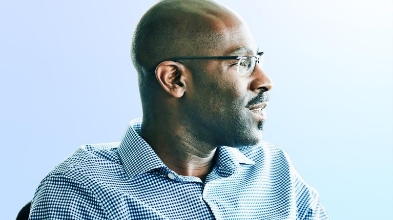 Portrait of mature businessman seated at workstation in design studio