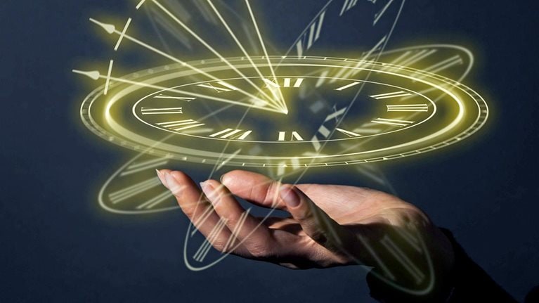 A glowing clock floats above an open palm.