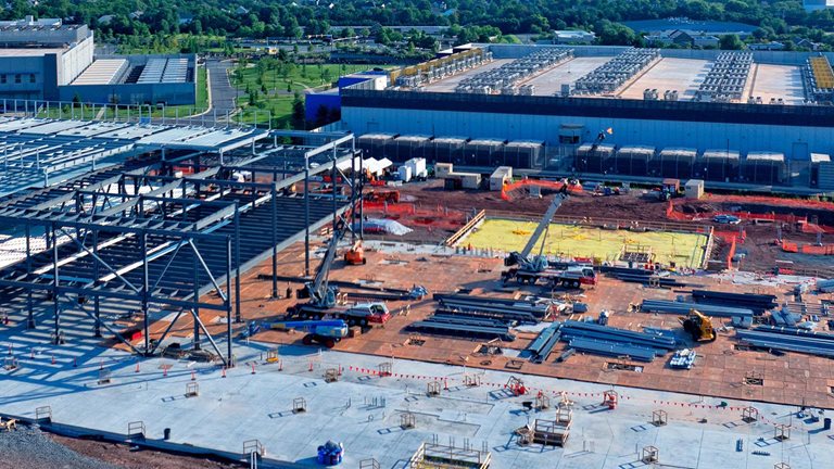 Aerial view of a data center being constructed among existing centers