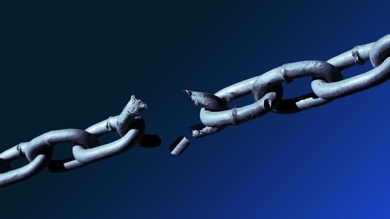 Close-up of metallic chain breaking