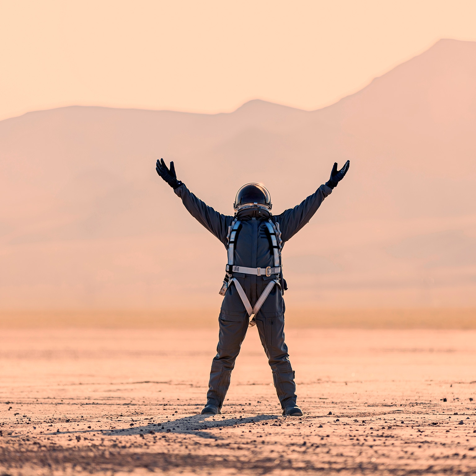 Astronaut raises hands to the sky