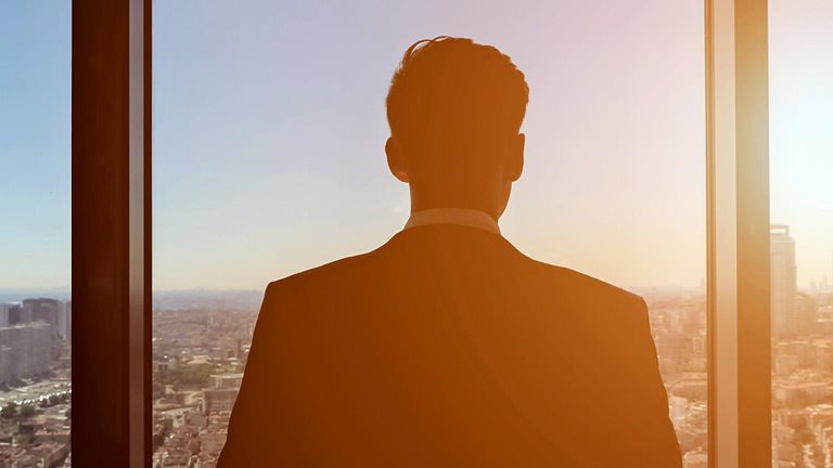 Businessman looking at panoramic city view through a window