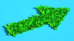 Digital generated image of arrow made out of green leaves on blue background.