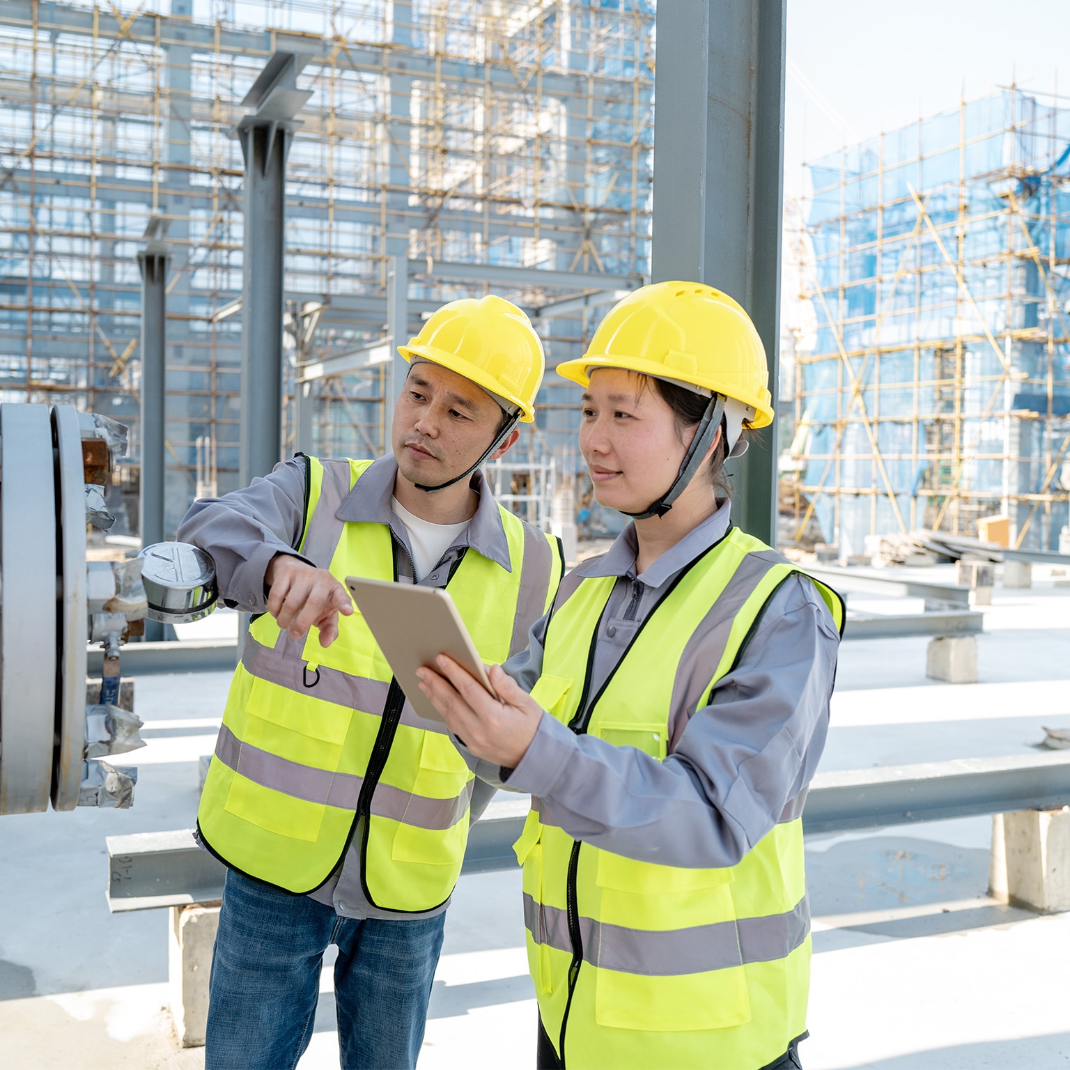 Two male and female engineers are checking equipment in the chemical plant - stock photo