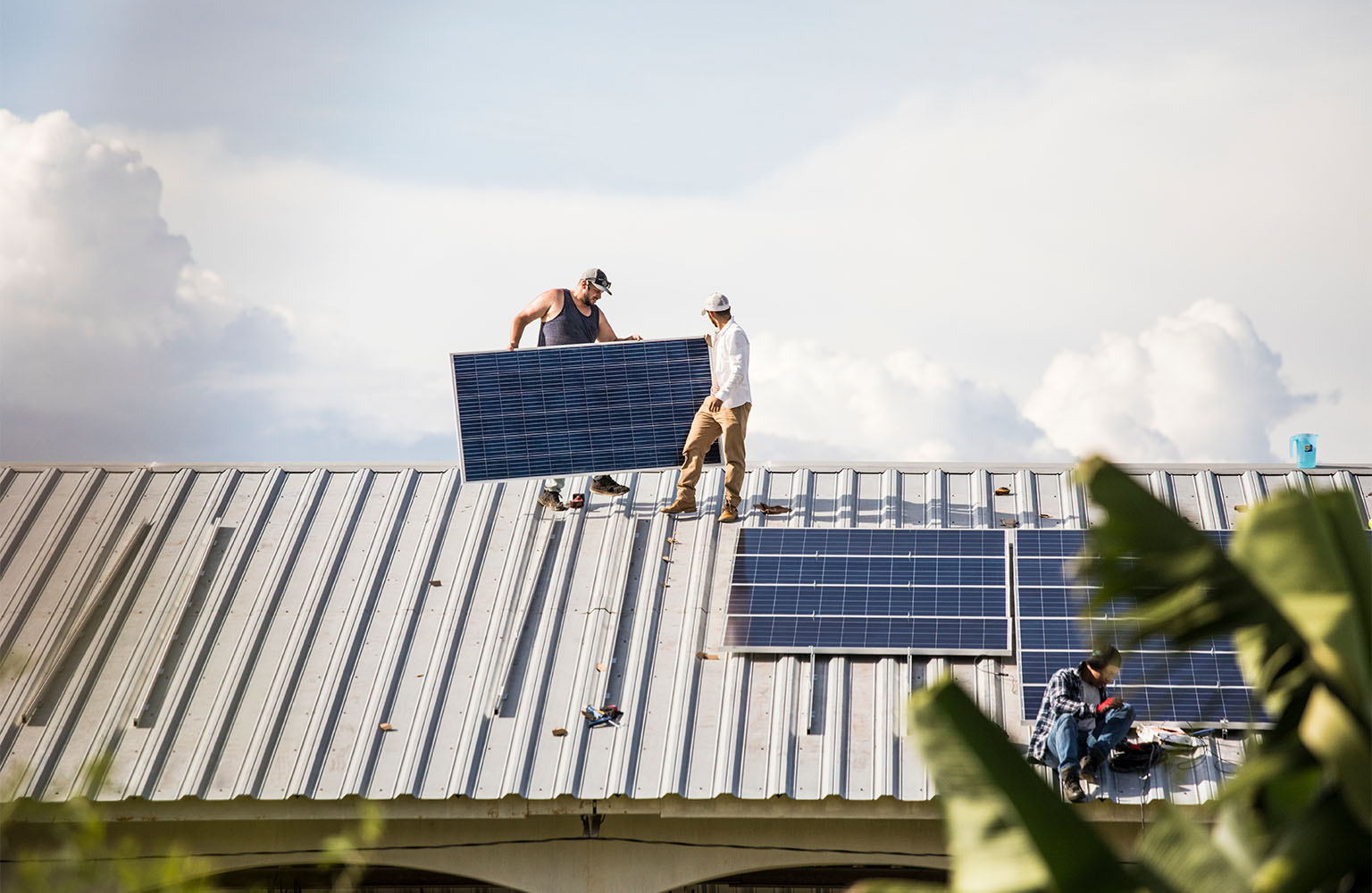 People installing solar panels on a roof