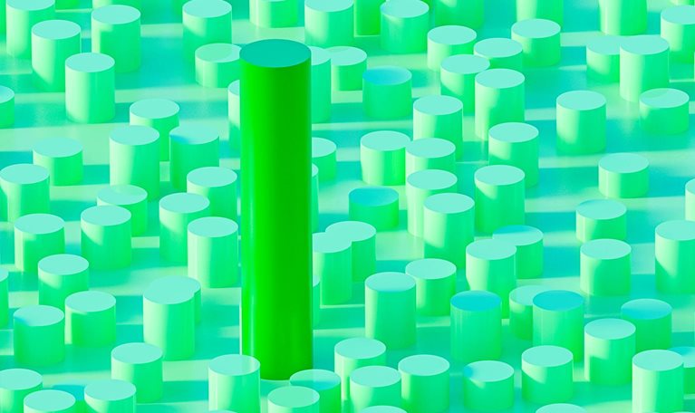 Green cylinder stands taller than surrounding shorter ones