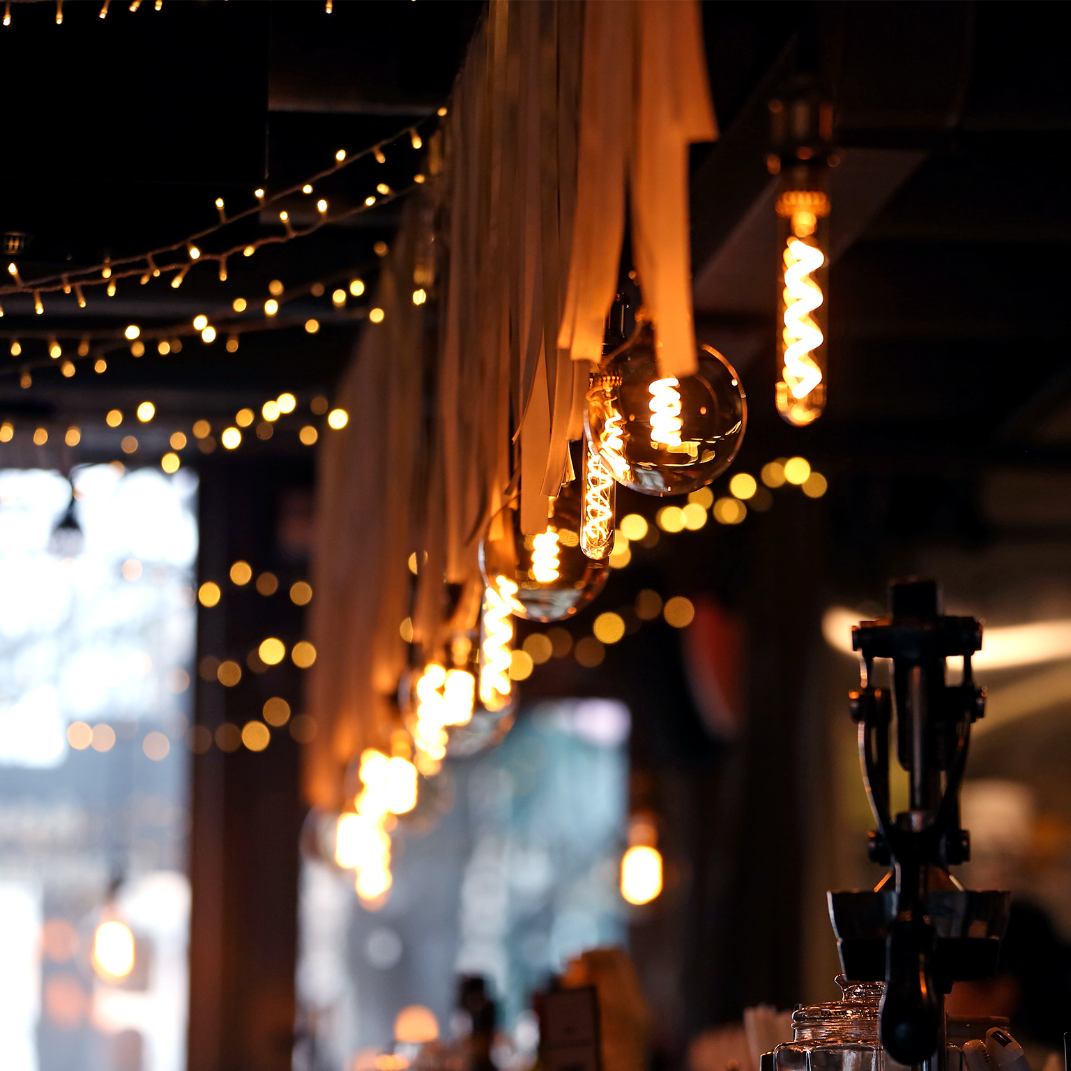 Small Local Business Concept. Low View For Cozy Bar Counter With Beer Tap Silhouette And Craft Electric Lamps And Garlands, Selective Focus, Copy Space