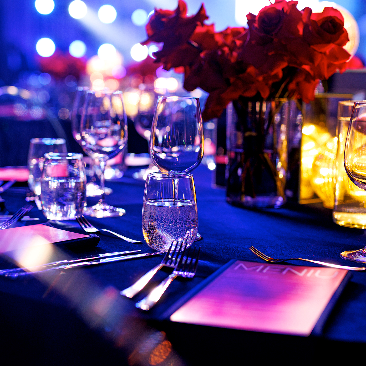 Elegant Gala Dinner Table Setting with Red Roses and Wine Glasses