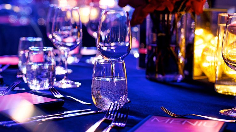 Elegant Gala Dinner Table Setting with Red Roses and Wine Glasses