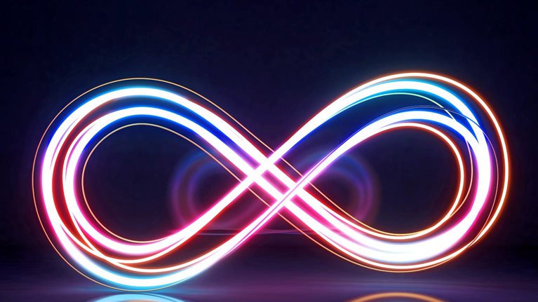A glowing infinity symbol is formed by intertwined neon light trails in vibrant shades of pink, blue, and orange against a dark background.